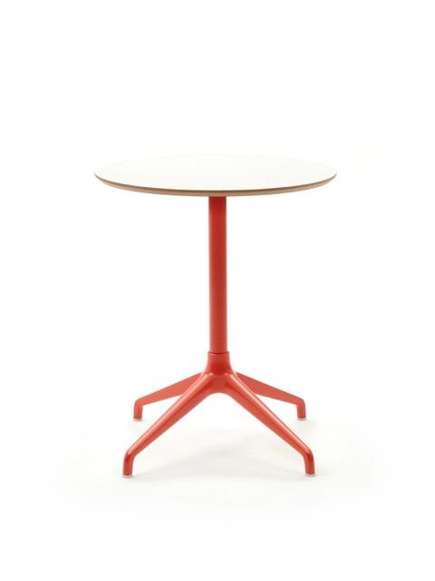 Small round white table with a red pedestal base and four angled legs, isolated on white background