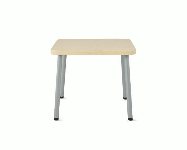 Small light wood table with gray metal legs on a white background