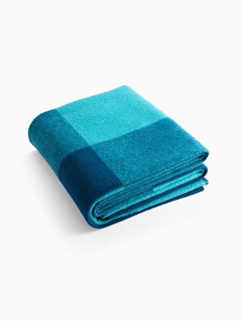 Folded blue checkered blanket on a white background