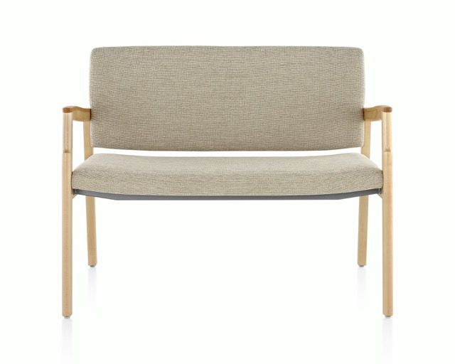 Beige upholstered bench with light wood frame on a white background