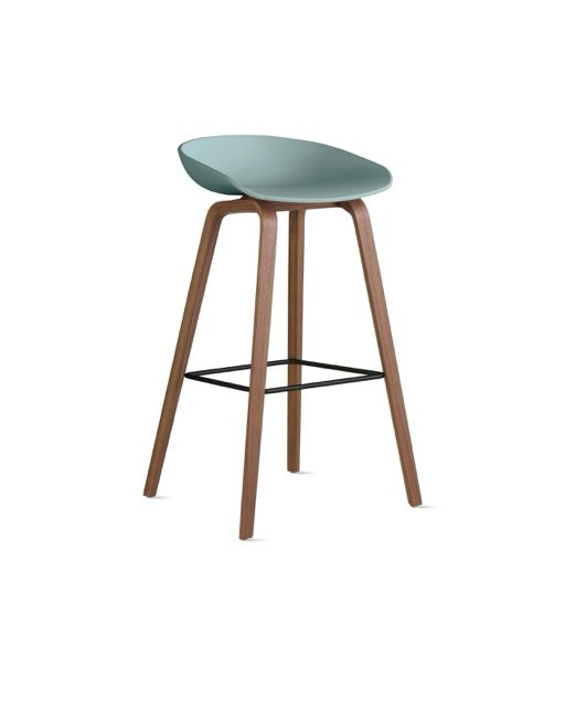 Modern bar stool with teal seat, wooden legs, and a black footrest on a white background