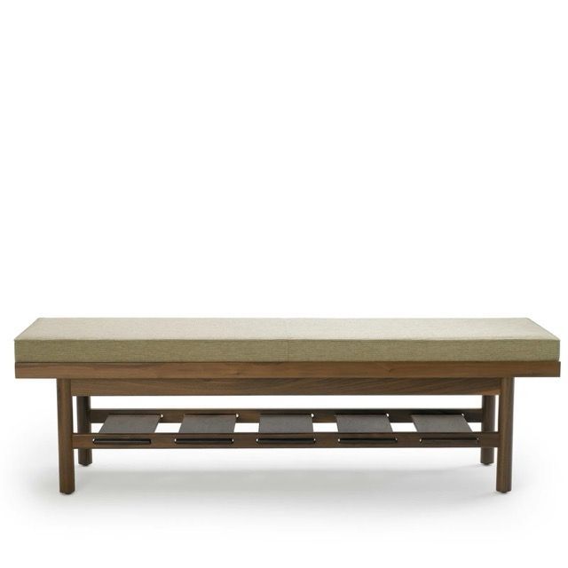 Simple wooden bench with a beige cushioned seat and lower shelf on a white background