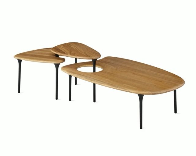 Three modern wooden coffee tables with black metal legs, arranged in a nested cluster.