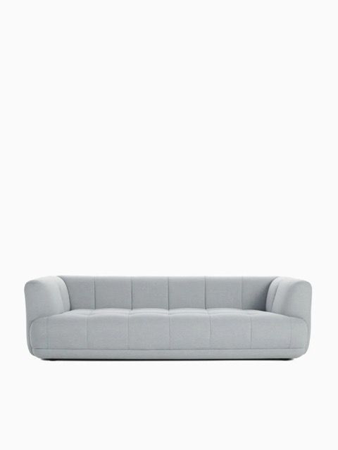 Light gray modern sofa with rounded arms on a white background