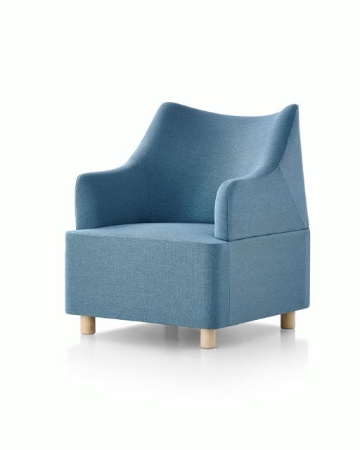 Blue upholstered armchair with wooden legs on a white background