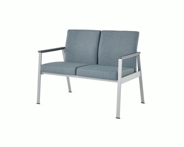 Gray two-seat outdoor bench with metal frame and armrests on a white background