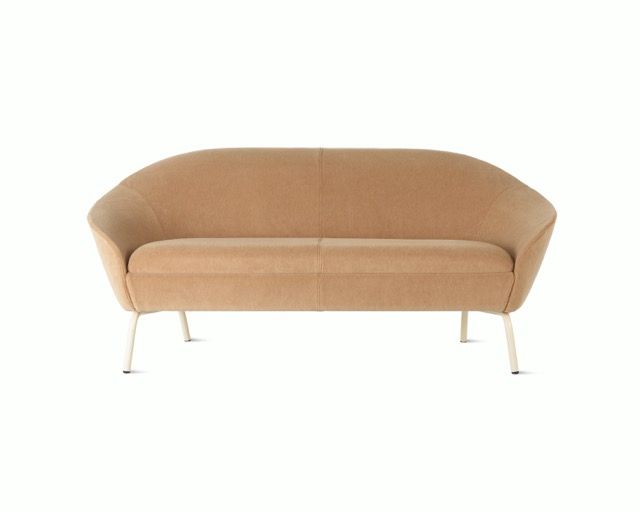 Beige upholstered sofa with slim metal legs on a white background