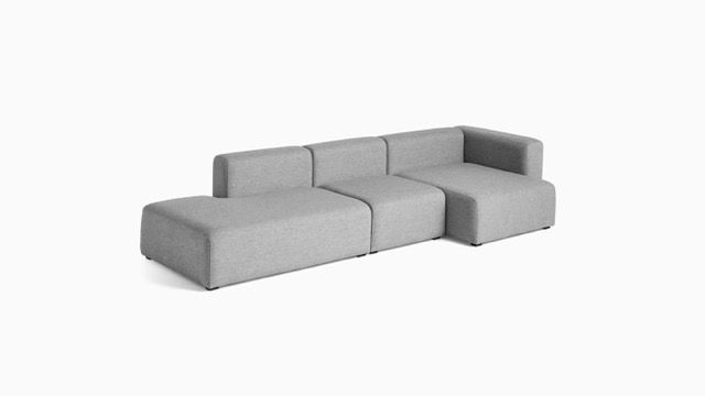 Gray L-shaped sectional sofa with low back and armrests on a white background