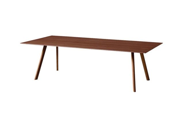 Modern wooden dining table with tapered legs on a white background