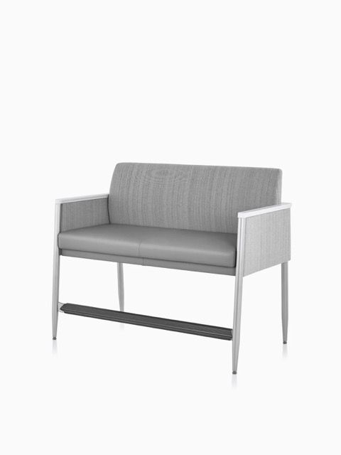 Gray upholstered two-seat sofa with light wood legs on a white background