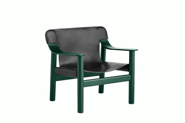 Green wooden armchair with black leather seat and backrest on a white background