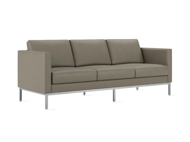 Modern beige three-seat sofa with metal legs on a white background
