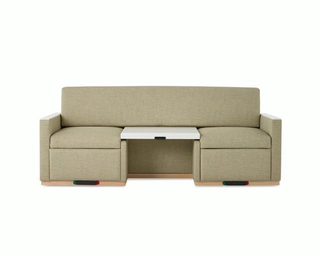 Beige sofa with center storage console and pull-out footrests against a white background