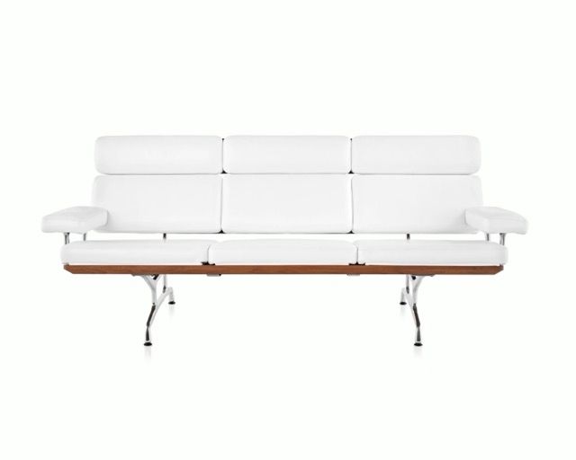 White modern loveseat with wooden base and chrome legs on a white background