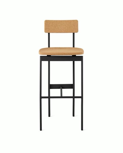 Tall black bar stool with tan upholstered seat and backrest on a white background