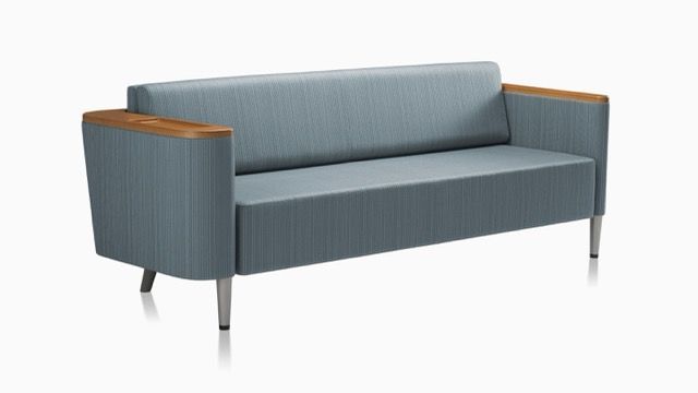 Modern dark gray sectional sofa with built-in side table on a white background