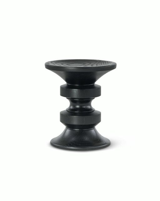 Black stool-shaped suction cup massage tool on a white background