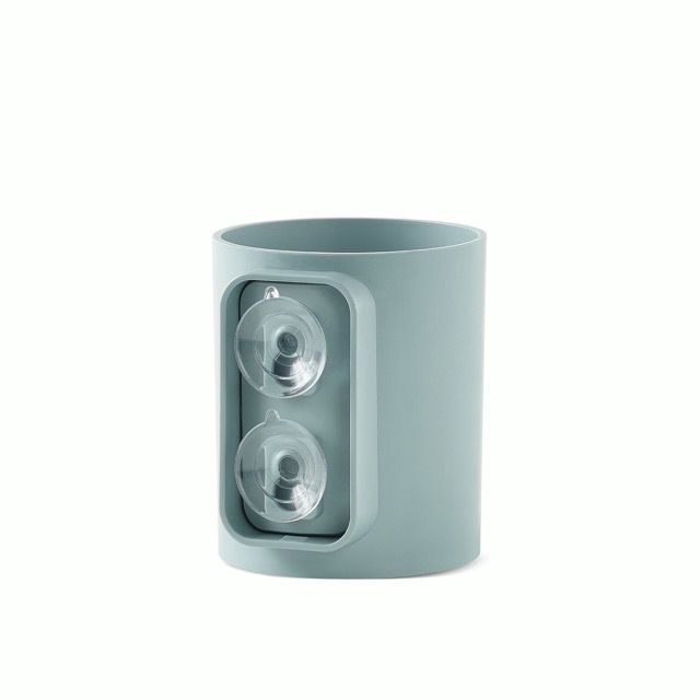 Light blue mug holding black pens on a white background