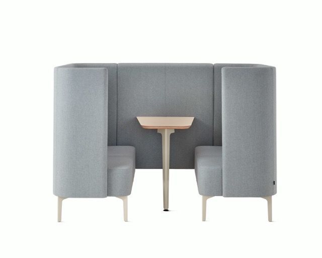 Gray booth seating with a small table in the center