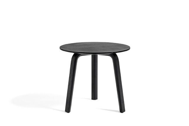 Black three-legged round stool on a white background