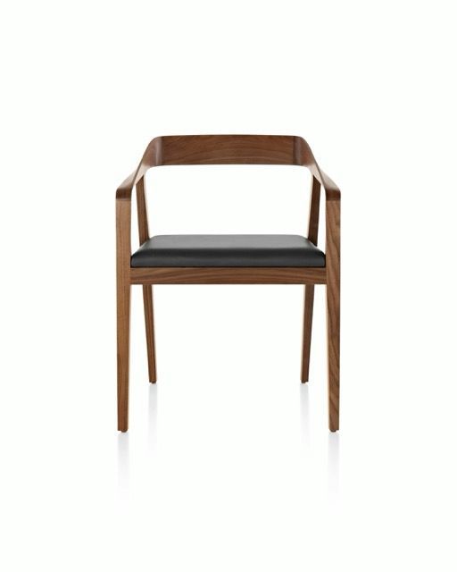 Modern wooden chair with dark seat cushion on a white background