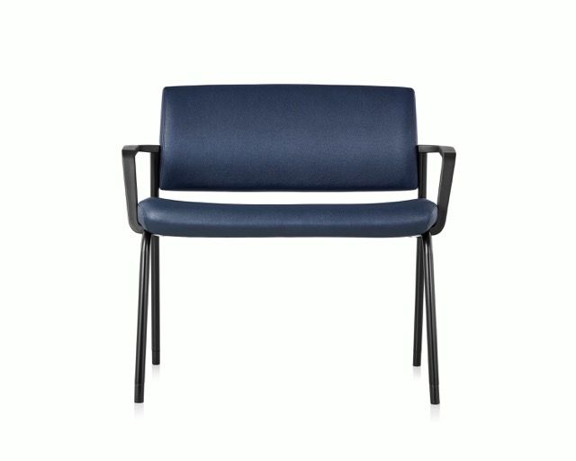 Blue upholstered chair with black metal legs and armrests on a white background