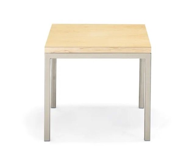 Small light wood table with four silver legs on a white background
