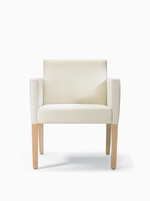White upholstered armchair with light wooden legs on a white background