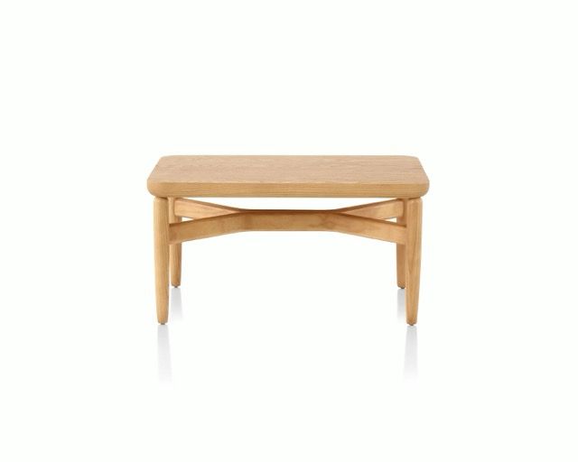 Light wood bench with a simple curved frame on a white background
