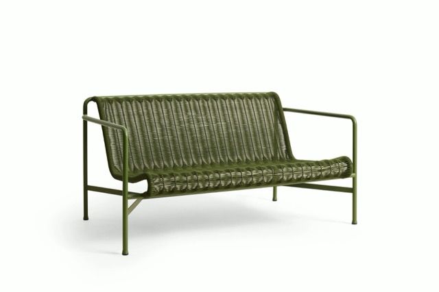 Olive-green woven loveseat with metal frame on a white background