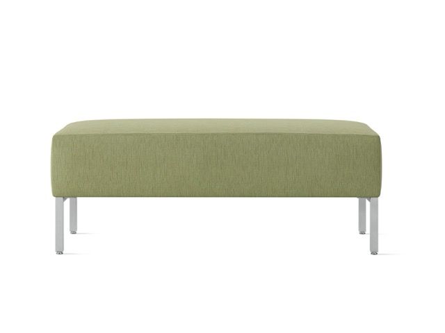 Olive green upholstered bench with slim silver legs on a white background