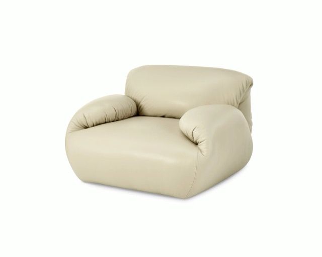 Beige upholstered armchair with rounded arms and back on a white background