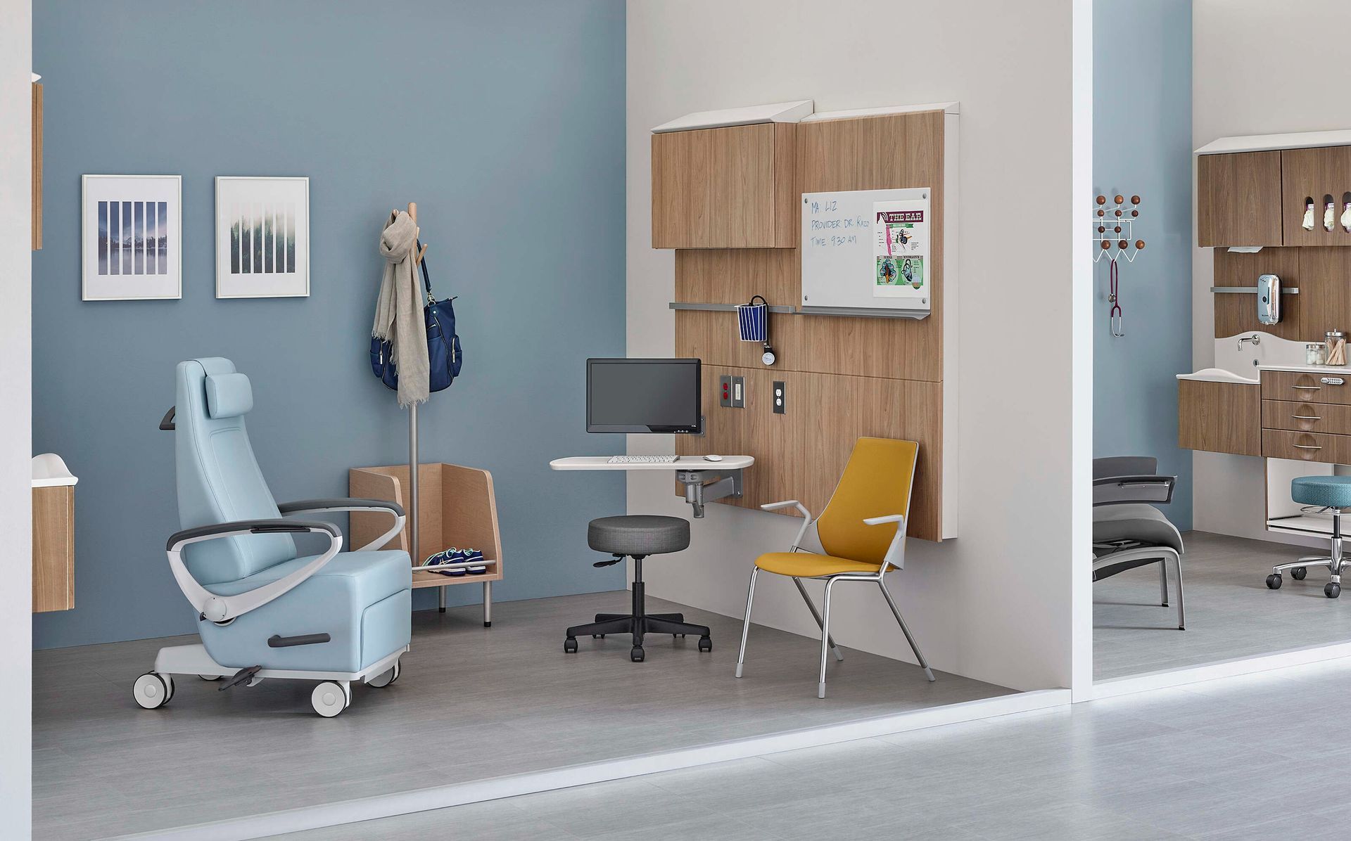 Modern dental clinic with blue chair, desk, yellow chair, and wood cabinets in a clean exam room