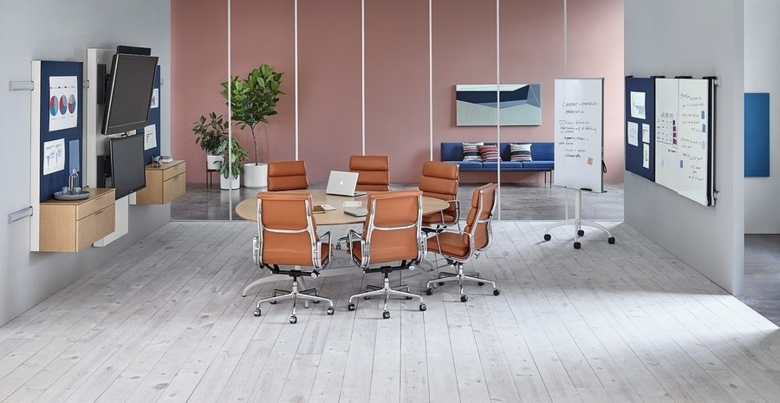 Modern office workspace with blue walls, desks, stools, shelves, and pinned notes on display boards