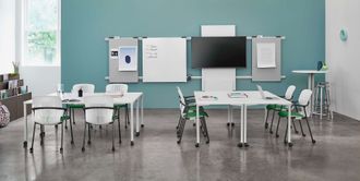 Modern classroom with desks, whiteboard, TV, and green chairs against a teal wall