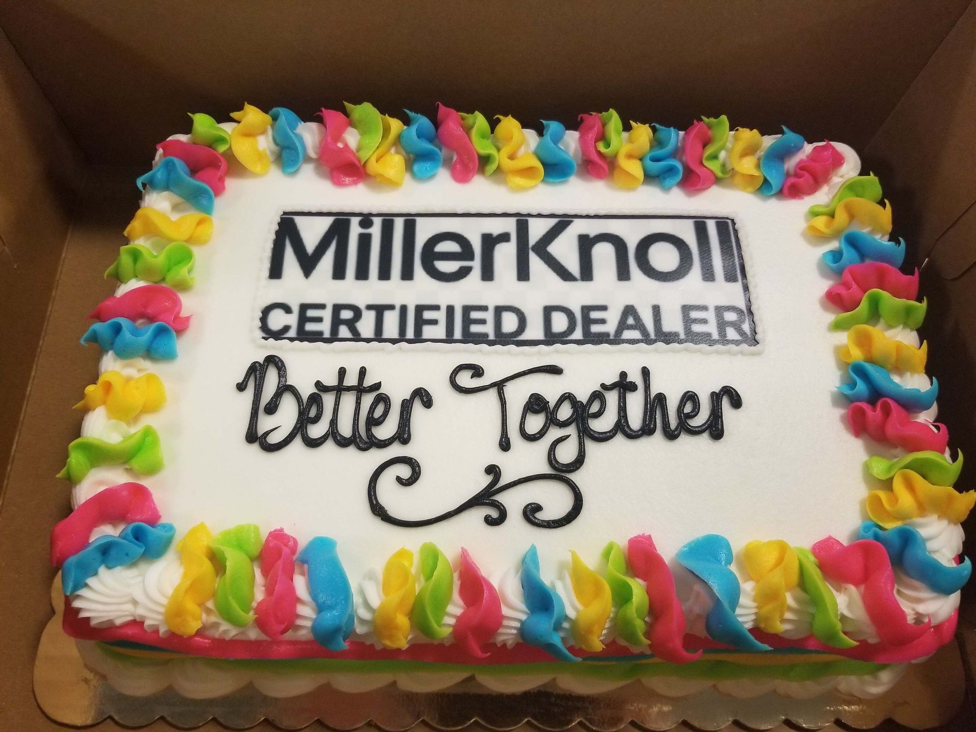 MillerKnoll Certified Dealer cake with colorful frosting and the words “Better Together”