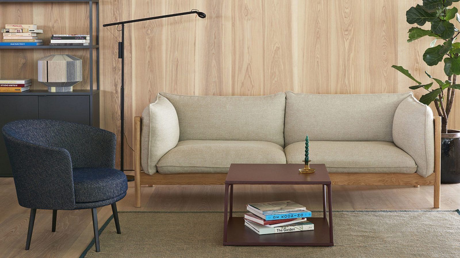 Black leather loveseat with metal frame on a white background