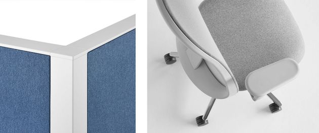 Gray office chair beside blue cubicle panels and a white desk corner