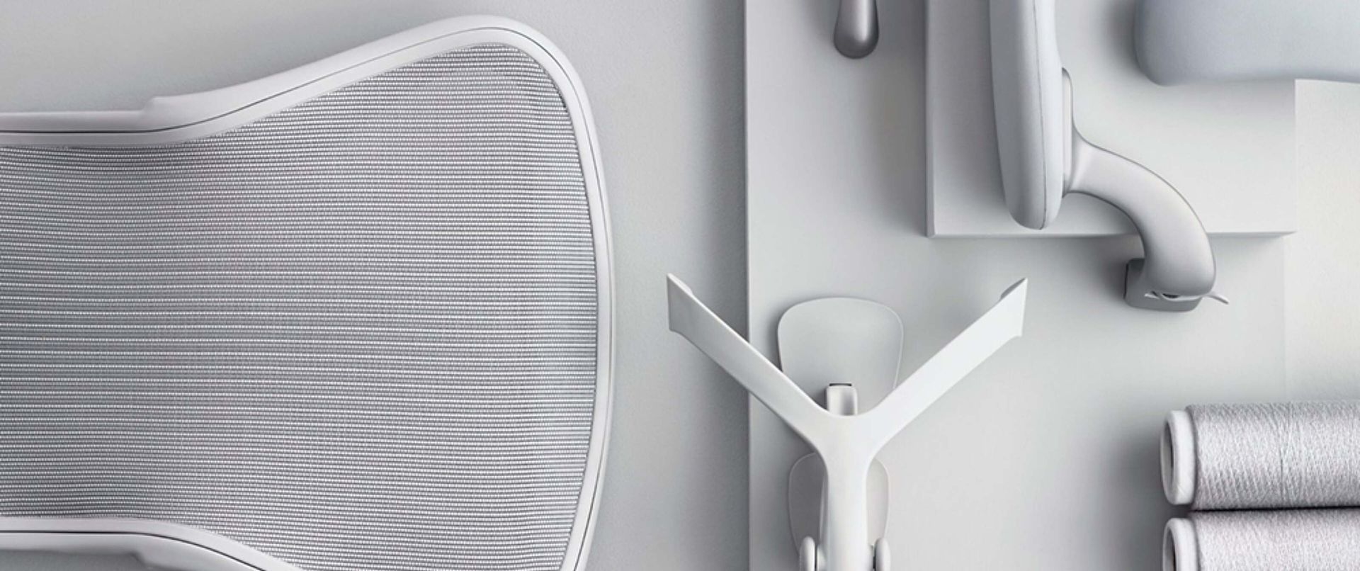 White workspace items on a gray background: chair edge, desk lamp, and small organizer.