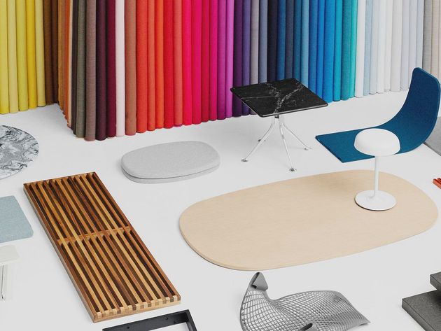 Colorful chairs and tables in a modern showroom with a bright gradient wall backdrop