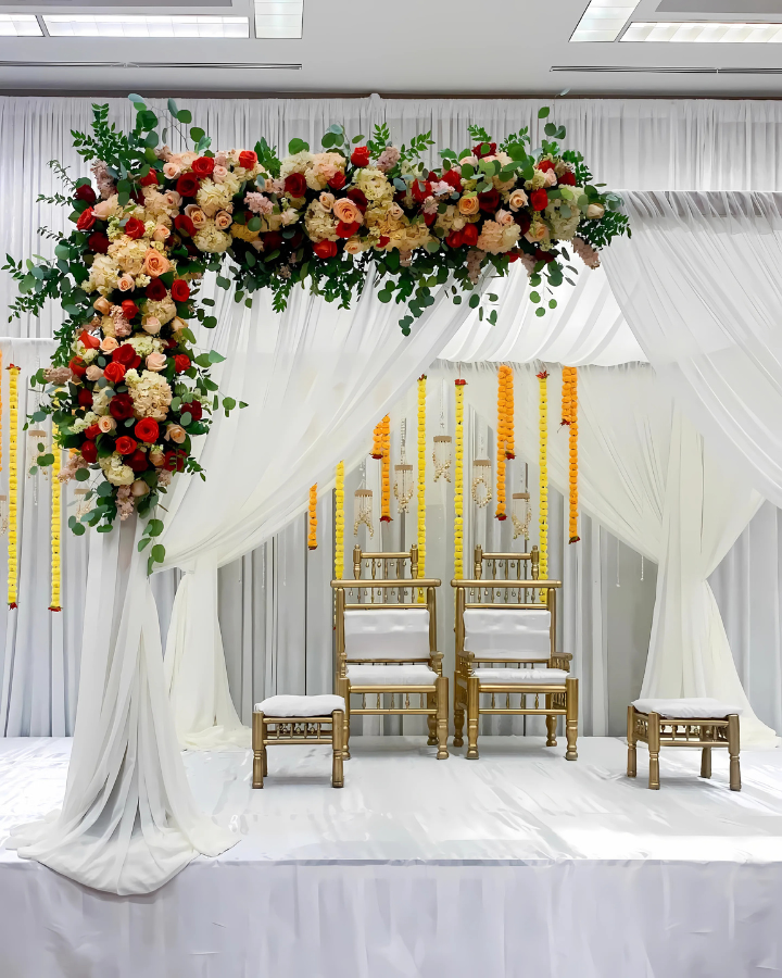 A stage with chairs and flowers on it