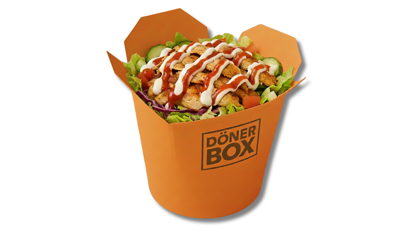 Döner Kebab Salat mit Soße in einer orangefarbenen Pappschachtel mit der Aufschrift 