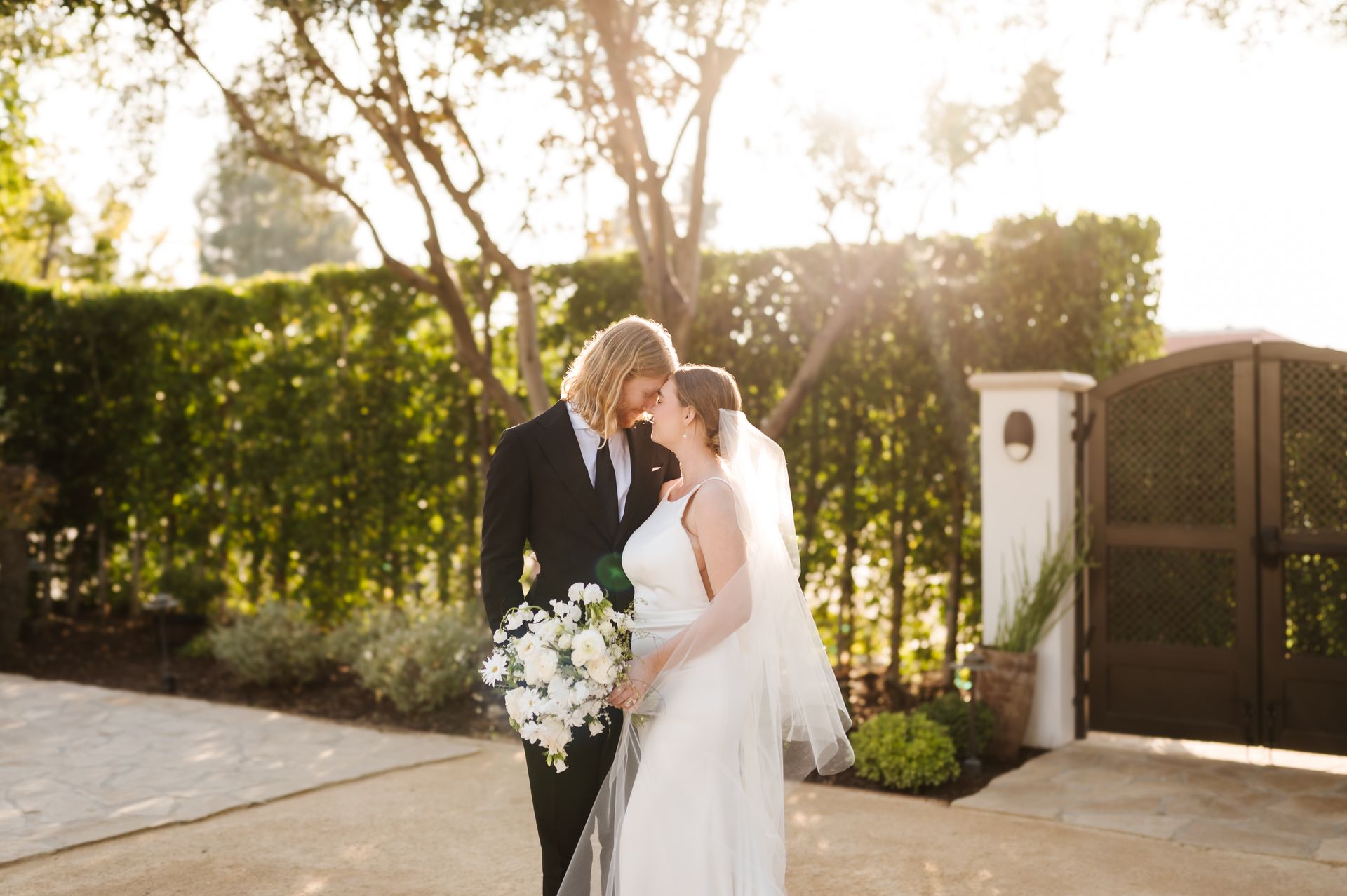 A bride and groom are posing for a picture on their wedding day at the Grand Gimeno.