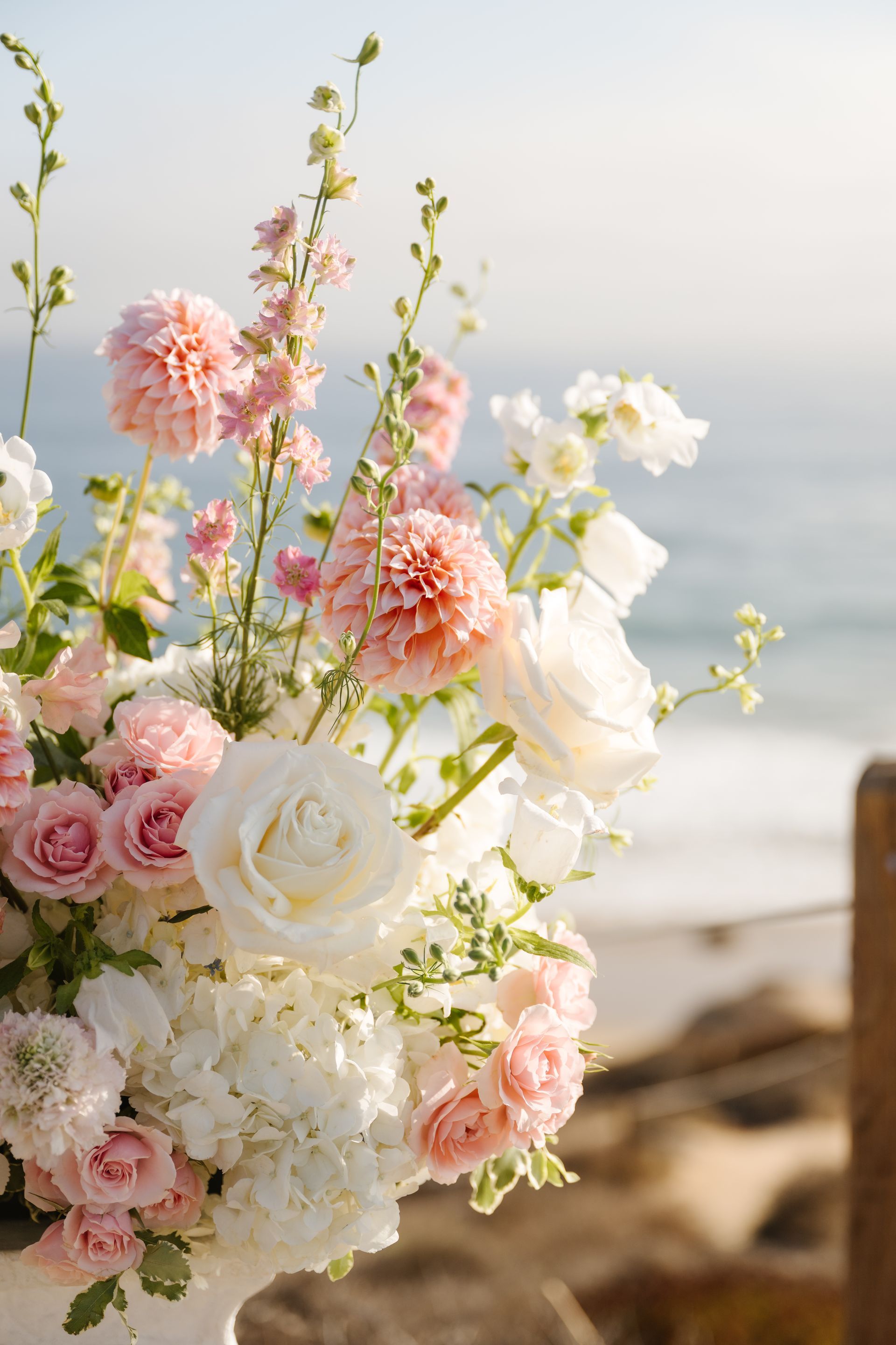 Pink and white flowers in a bouquet by the sea