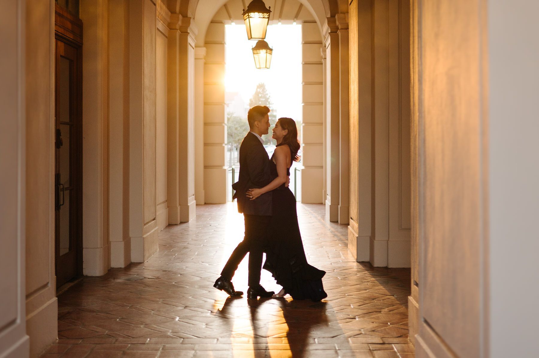 A man and a woman are dancing in a hallway at Pasadena City Hall.
