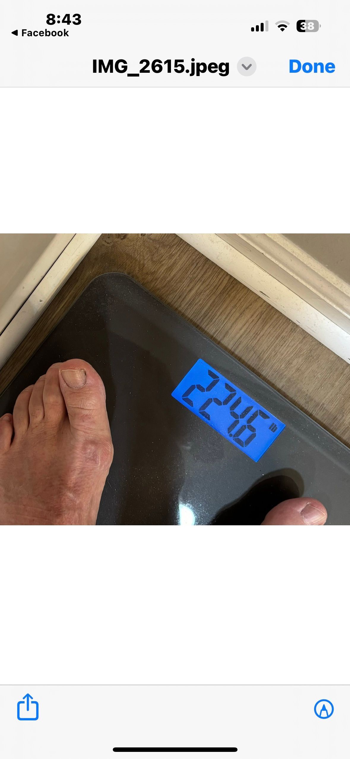 A person is standing on a scale with their foot on it.
