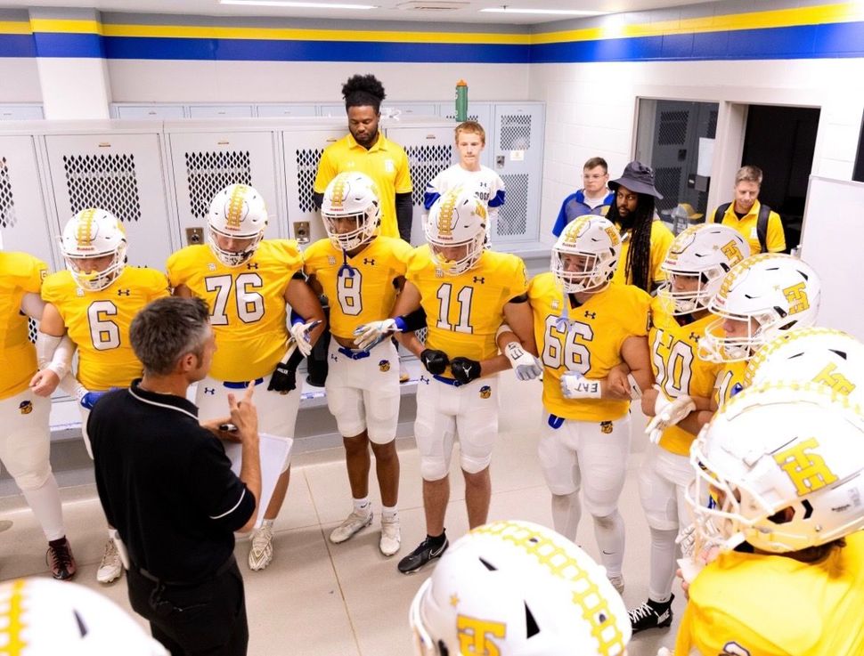 Student-athlete receiving coaching on the sideline