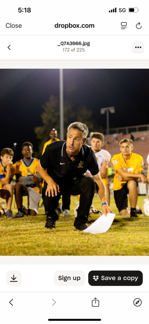 TR Athletics coach with student-athlete on the sideline