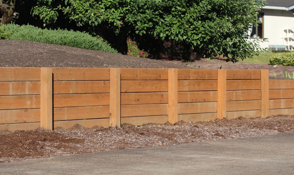 Wooden Retaining Wall With Vertical Posts and Horizontal Planks — B&T Earthworks & Civil in Gordonvale, QLD