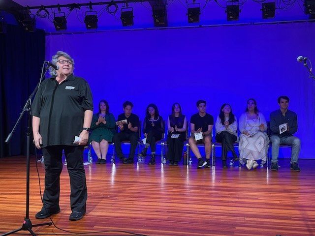 The director Mary Iannelli on stage with participants